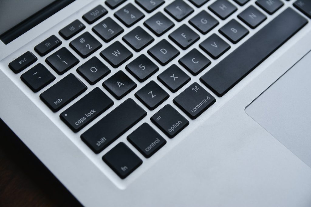 silver and black laptop computer used to type seo keywords
